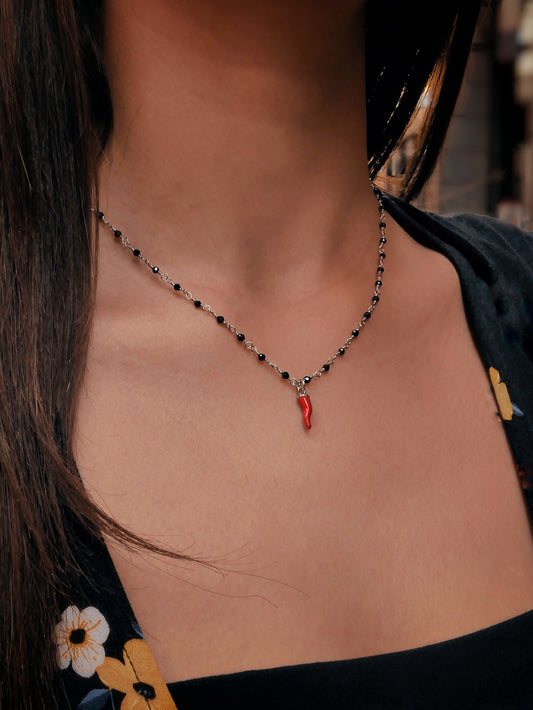 Collana in argento con cornetto e sfere